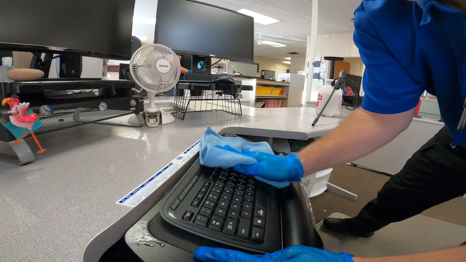 Technician detail-cleaning a Toledo office workstation