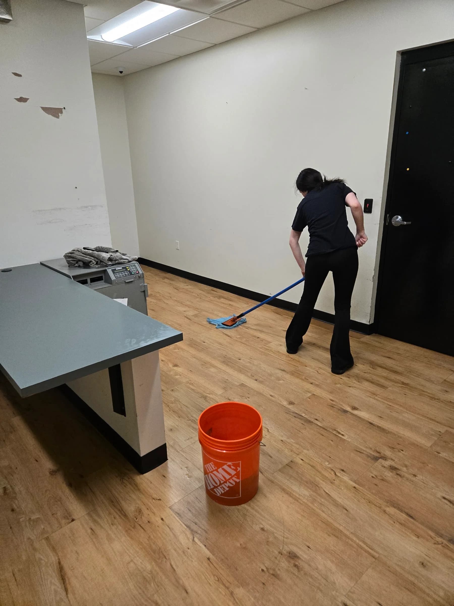 SWAT technician damp-mopping a commercial floor — Michigan company portfolio